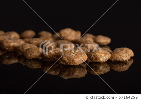 Choco balls cereal isolated on black glass Choco balls cereal isolated on black glass 57164259