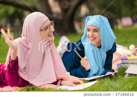 Cheerful muslim students feeling amazing while studying together 57166018