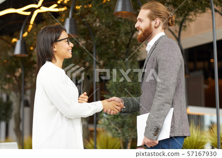 Business partners shaking hands outdoors 57167930