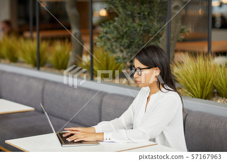 Serious manager typing on laptop Serious manager typing on laptop 57167963