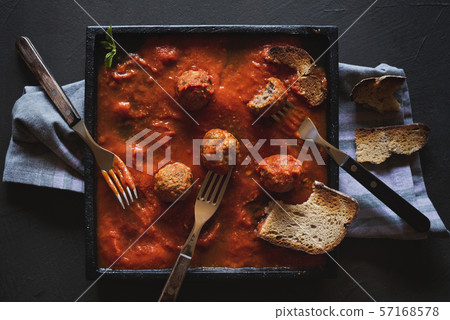 Dinner table with meatballs and tomato sauce Dinner table with meatballs and tomato sauce 57168578