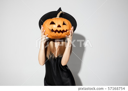 Young woman in hat as a witch on white background Young woman in hat as a witch on white background 57168754