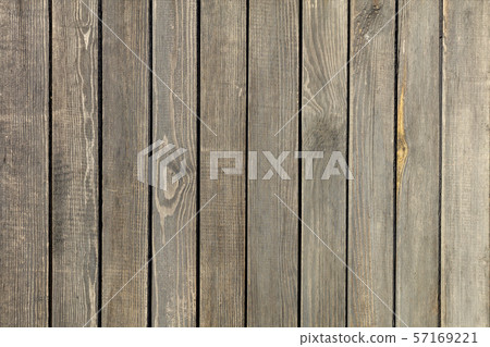 Weathered old gray wooden fence close-up. Weathered old gray wooden fence close-up. 57169221