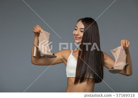 Beautiful young woman with beige shoes Beautiful young woman with beige shoes 57169318