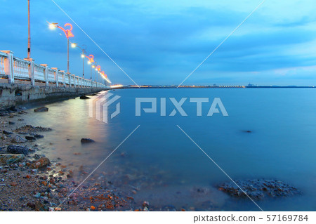 Seascape at sunset twilight On the beach rocks Along the bridge Viewpoint Seascape at sunset twilight On the beach rocks Along the bridge Viewpoint 57169784