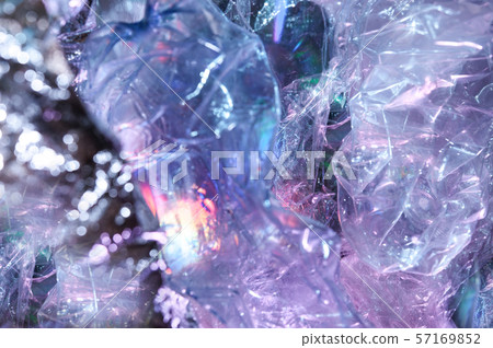 Holographic background in the style of the 80-90s. Real texture of cellophane film in bright acid Holographic background in the style of the 80-90s. Real texture of cellophane film in bright acid 57169852