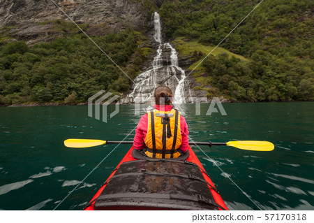 Little kayak in a lake or in a big river with a Little kayak in a lake or in a big river with a 57170318