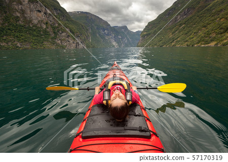 Little kayak in a lake or in a big river with a Little kayak in a lake or in a big river with a 57170319
