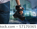 Young man holds black modern digital camera 57170365