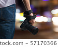 Young man holds black modern digital camera 57170366