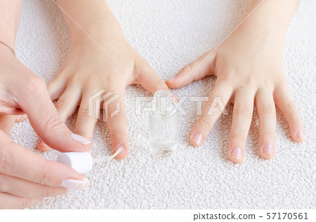 mother paints her child's nails with special nail polish by chewing finger nails mother paints her child's nails with special nail polish by chewing finger nails 57170561