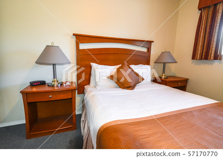Interior of bedroom with radio watch, perfume vail, and lamps on bedside tables. Interior of bedroom with radio watch, perfume vail, and lamps on bedside tables. 57170770
