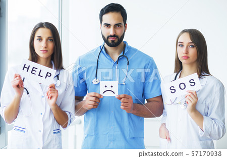 Health Care. Medical Team Holding Inscriptions For Help at the Hospital All Together. Doctor's Team. 57170938