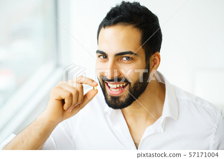 Beautiful Man Taking Pill, Medicine. Vitamins And Supplements Beautiful Man Taking Pill, Medicine. Vitamins And Supplements 57171004