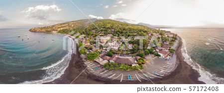 Aerial view of Amed beach in Bali, Indonesia. Traditional fishing boats called jukung on the black 57172408