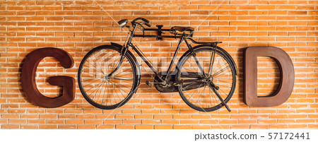 Inscription GOOD written with letters and a bicycle on the background of a brick wall. Eco-friendly Inscription GOOD written with letters and a bicycle on the background of a brick wall. Eco-friendly 57172441