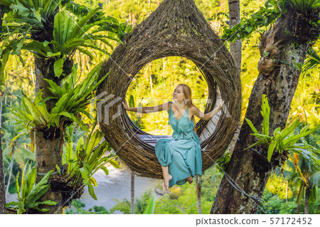 Bali trend, straw nests everywhere. Young tourist enjoying her travel around Bali island, Indonesia Bali trend, straw nests everywhere. Young tourist enjoying her travel around Bali island, Indonesia 57172452