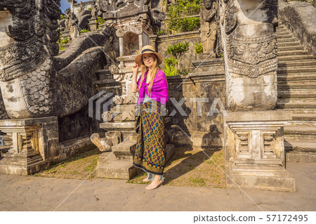 Young woman tourist on background of Three stone ladders in beautiful Pura Lempuyang Luhur temple 57172495