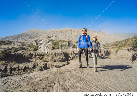 Young couple man and woman visit the Bromo volcano at the Tengger Semeru National Park on the Java Young couple man and woman visit the Bromo volcano at the Tengger Semeru National Park on the Java 57172848