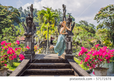 Young woman tourist in Taman Tirtagangga, Water palace, Water park, Bali Indonesia Young woman tourist in Taman Tirtagangga, Water palace, Water park, Bali Indonesia 57172878