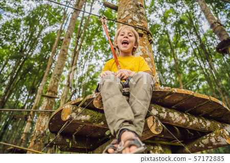 Little boy in a rope park. Active physical recreation of the child in the fresh air in the park Little boy in a rope park. Active physical recreation of the child in the fresh air in the park 57172885