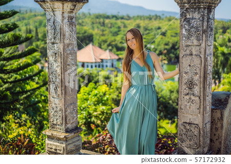 Young woman in dress in Water Palace Soekasada Taman Ujung Ruins on Bali Island in Indonesia 57172932