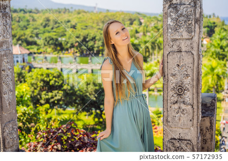 Young woman in dress in Water Palace Soekasada Taman Ujung Ruins on Bali Island in Indonesia 57172935