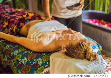 Young beautiful relaxing woman getting spa massage of shoulder in beauty salon Young beautiful relaxing woman getting spa massage of shoulder in beauty salon 57173417