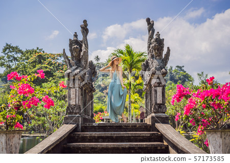 Young woman tourist in Taman Tirtagangga, Water palace, Water park, Bali Indonesia Young woman tourist in Taman Tirtagangga, Water palace, Water park, Bali Indonesia 57173585