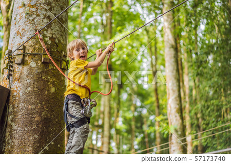 Little boy in a rope park. Active physical recreation of the child in the fresh air in the park 57173740