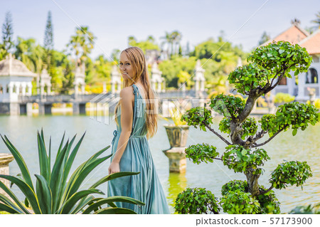 Young woman in dress in Water Palace Soekasada Taman Ujung Ruins on Bali Island in Indonesia Young woman in dress in Water Palace Soekasada Taman Ujung Ruins on Bali Island in Indonesia 57173900