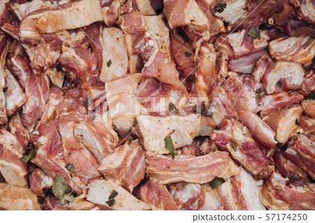 Many raw piece of fresh meat in marinade ready to 57174250