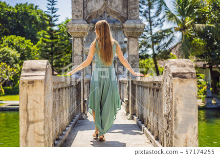 Young woman in dress in Water Palace Soekasada Taman Ujung Ruins on Bali Island in Indonesia Young woman in dress in Water Palace Soekasada Taman Ujung Ruins on Bali Island in Indonesia 57174255