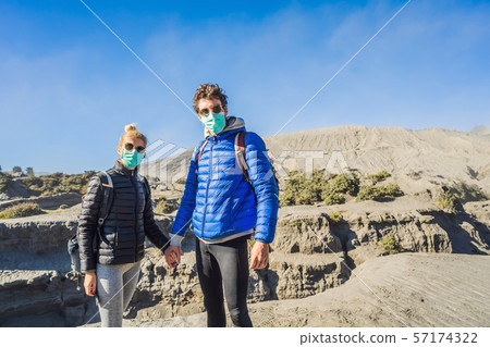 Young couple man and woman visit the Bromo volcano at the Tengger Semeru National Park on Java Young couple man and woman visit the Bromo volcano at the Tengger Semeru National Park on Java 57174322
