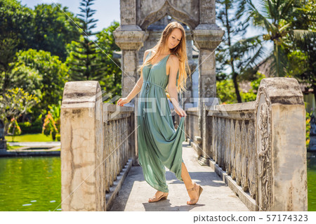 Young woman in dress in Water Palace Soekasada Taman Ujung Ruins on Bali Island in Indonesia Young woman in dress in Water Palace Soekasada Taman Ujung Ruins on Bali Island in Indonesia 57174323