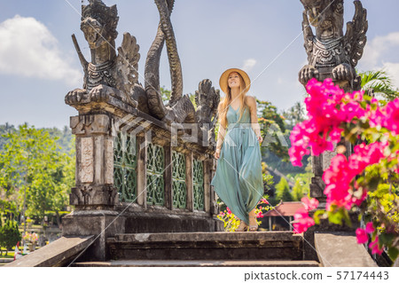 Young woman tourist in Taman Tirtagangga, Water palace, Water park, Bali Indonesia 57174443