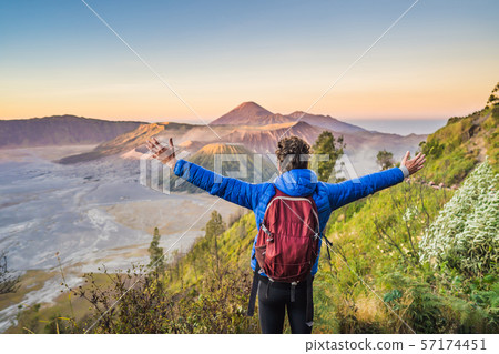 Young man meets the sunrise at the Bromo Tengger Semeru National Park on the Java Island, Indonesia 57174451