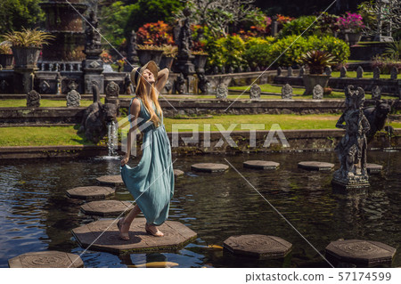 Young woman tourist in Taman Tirtagangga, Water palace, Water park, Bali Indonesia 57174599