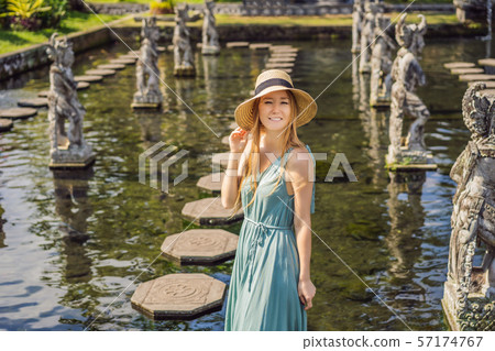 Young woman tourist in Taman Tirtagangga, Water palace, Water park, Bali Indonesia 57174767
