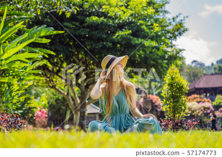 Young woman tourist in Taman Tirtagangga, Water palace, Water park, Bali Indonesia Young woman tourist in Taman Tirtagangga, Water palace, Water park, Bali Indonesia 57174773