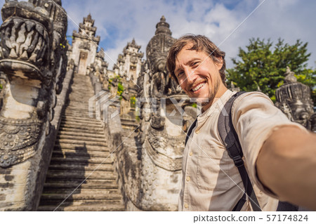 Young man tourist on background ofThree stone ladders in beautiful Pura Lempuyang Luhur temple Young man tourist on background ofThree stone ladders in beautiful Pura Lempuyang Luhur temple 57174824