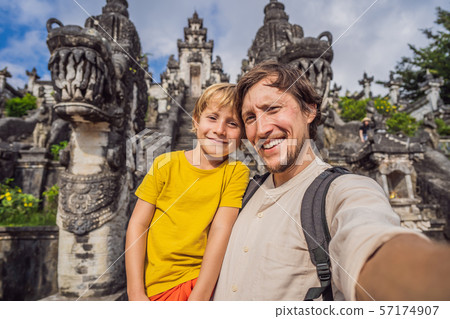 Dad and son tourists on background of Three stone ladders in beautiful Pura Lempuyang Luhur temple 57174907
