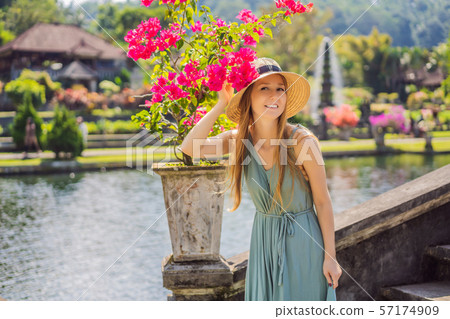 Young woman tourist in Taman Tirtagangga, Water palace, Water park, Bali Indonesia 57174909