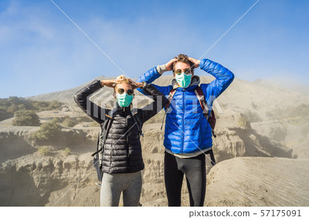 Young couple man and woman visit the Bromo volcano at the Tengger Semeru National Park on Java 57175091