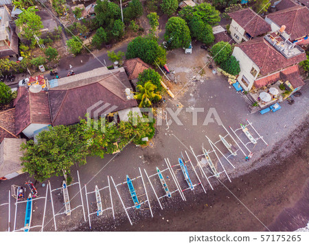 Aerial view of Amed beach in Bali, Indonesia. Traditional fishing boats called jukung on the black 57175265