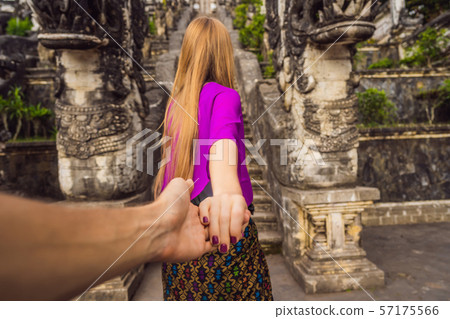follow me photo. Young woman tourist on background of Three stone ladders in beautiful Pura follow me photo. Young woman tourist on background of Three stone ladders in beautiful Pura 57175566