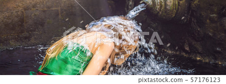 Woman in holy spring water temple in bali. The temple compound consists of a petirtaan or bathing Woman in holy spring water temple in bali. The temple compound consists of a petirtaan or bathing 57176123