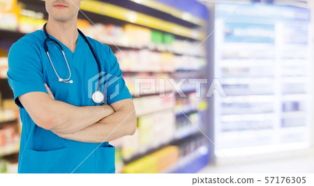 Male pharmacist working at the pharmacy. Male pharmacist working at the pharmacy. 57176305