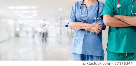 Doctor and surgeon with arms crossed in hospital. Doctor and surgeon with arms crossed in hospital. 57176344
