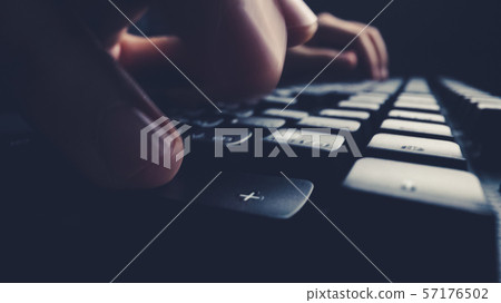 Close-up soft-focus finger typing on keyboard. Close-up soft-focus finger typing on keyboard. 57176502